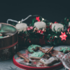 Assorted Christmas cookies in tins with candles and lights