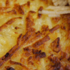 close up of browed cheesy hashbrowns