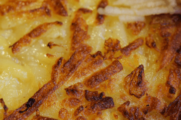 close up of browed cheesy hashbrowns