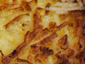 close up of browed cheesy hashbrowns