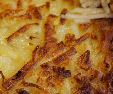 close up of browed cheesy hashbrowns